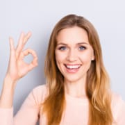 People body language facial emotion expressions people person concept. Close up portrait of excited lovely delightful cute confident manager making ok sign isolated on gray background coy-space