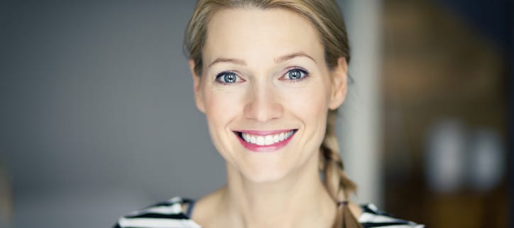 Smiling blond woman wearing a striped shirt