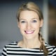 Smiling blond woman wearing a striped shirt