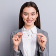 business lady perfect appearance beaming smiling taking off specs good eyesight