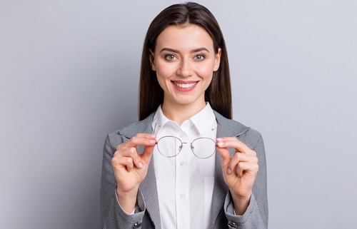 business lady perfect appearance beaming smiling taking off specs good eyesight