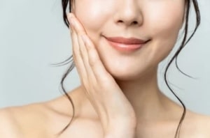 Close up of a woman smiling with softened smile lines after getting JUVEDERM XC injections.