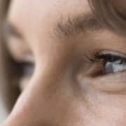 Close up of a woman's eyes looking to the side after improving her vision using bladeless LASIK.