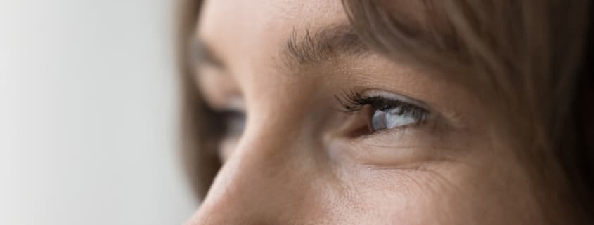 Close up of a woman's eyes looking to the side after improving her vision using bladeless LASIK.