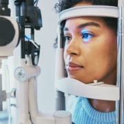 Patient undergoing a slit-lamp eye exam during a PRK recovery follow-up visit.