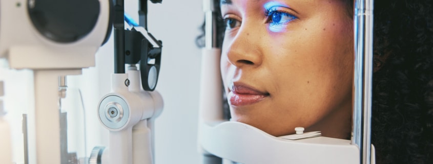 Patient undergoing a slit-lamp eye exam during a PRK recovery follow-up visit.