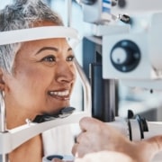 Older woman having her eyes examined to determine how presbyopia might affect her LASIK treatment.