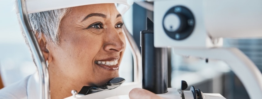 Older woman having her eyes examined to determine how presbyopia might affect her LASIK treatment.